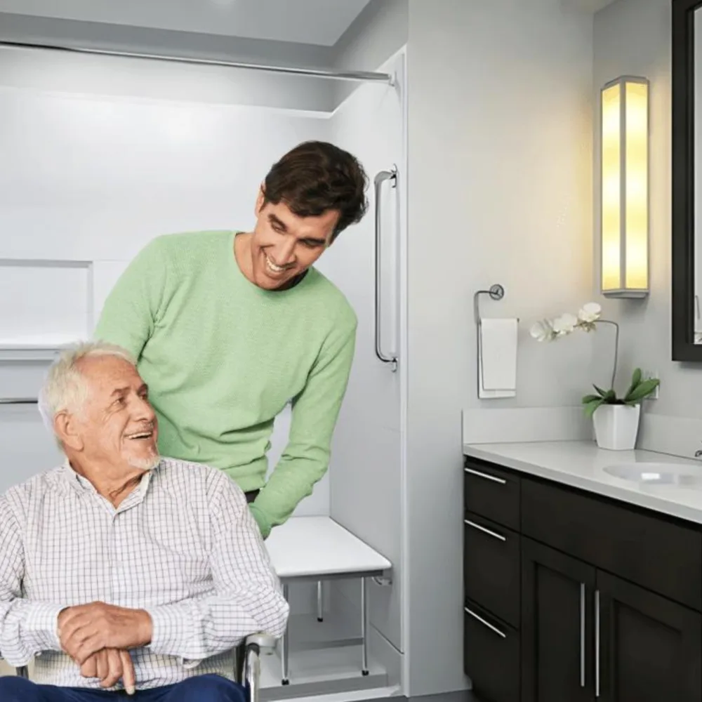 Accessible shower with senior wheelchair user and caregiver